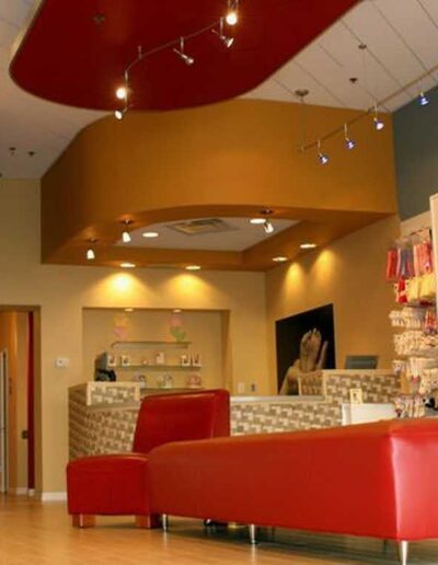 Modern retail store interior with colorful decoration and shelving displaying products.